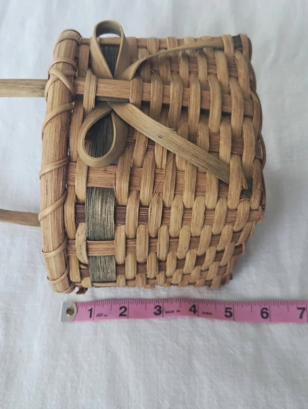 Vintage, Hand-Woven Basket Featuring A Unique Bow Detail And Green Accent